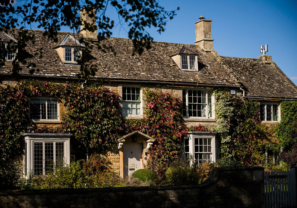 period home with trailing greenery in the Cotswolds