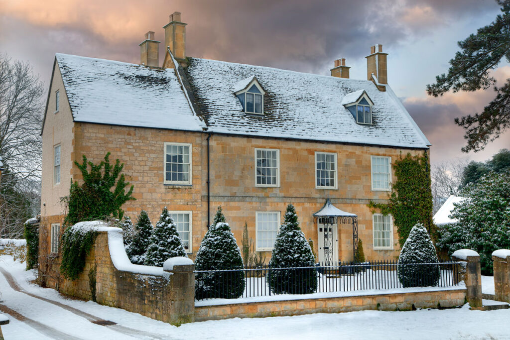 Detached Cotswolds stone house in the snow