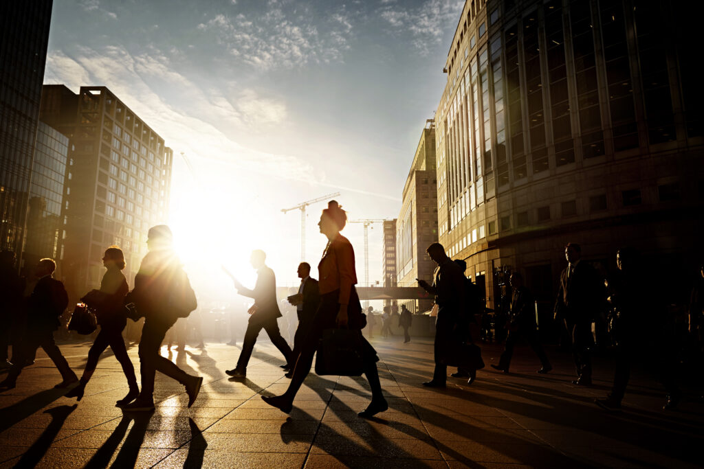Employees walking to work in the city at sunrise