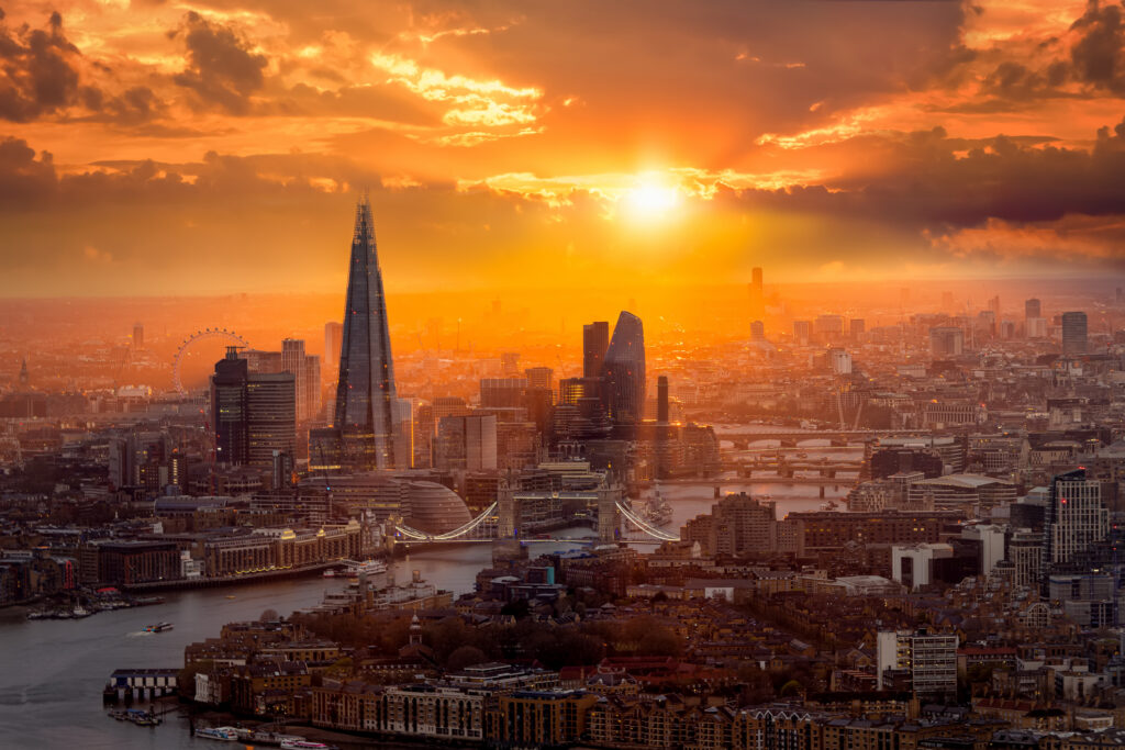 A beautiful sunset behind the London skyline with Tower Bridge, River Thames and the corporate skyscrapers